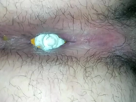 Fetish-filled scene with a hunky guy and his trusty butt plug. Camera zooms in for a close-up of the action as he eases the ball into his rear. A tantalizing display of anal play.