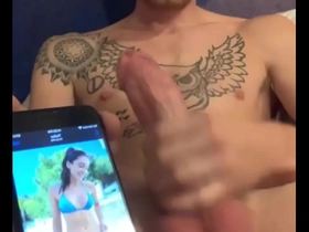 A young dude with a big cock and tattoos fulfills a request to cum on a bikini-clad babe. He jerks off, stroking his big cock, and releases a massive load in a steamy solo session.