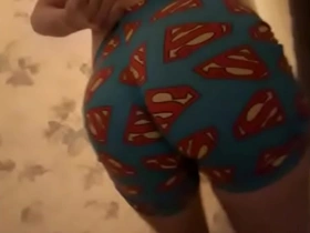 A youthful gay lad, clad in Superman pajamas, indulges in self-pleasure. His hands explore his rigid shaft, aiming for an explosive climax, all captured on a personal camcorder.